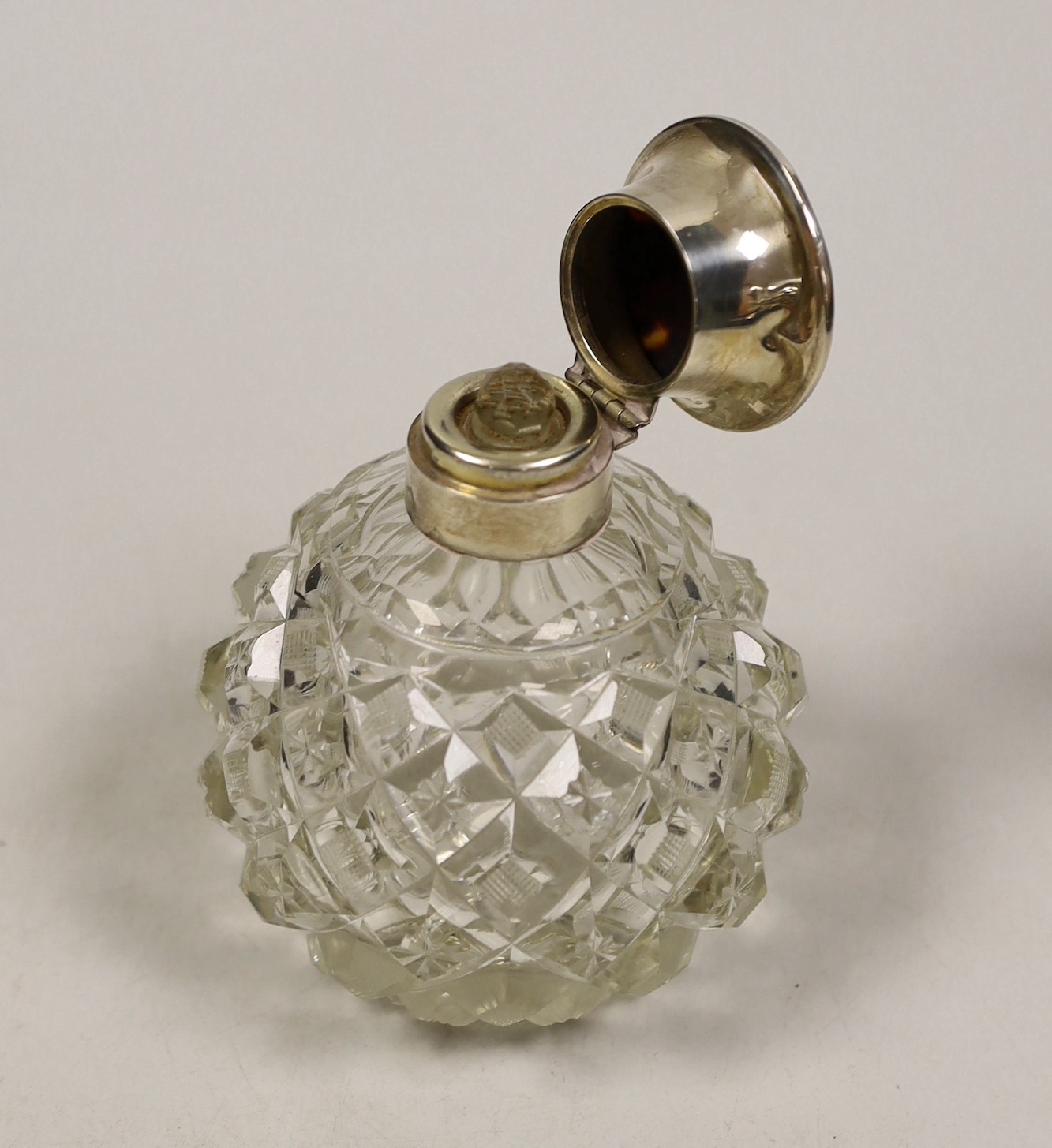 A George V silver and tortoiseshell pique mounted heavy cut glass scent bottle, London, 1921, height 12.5cm.